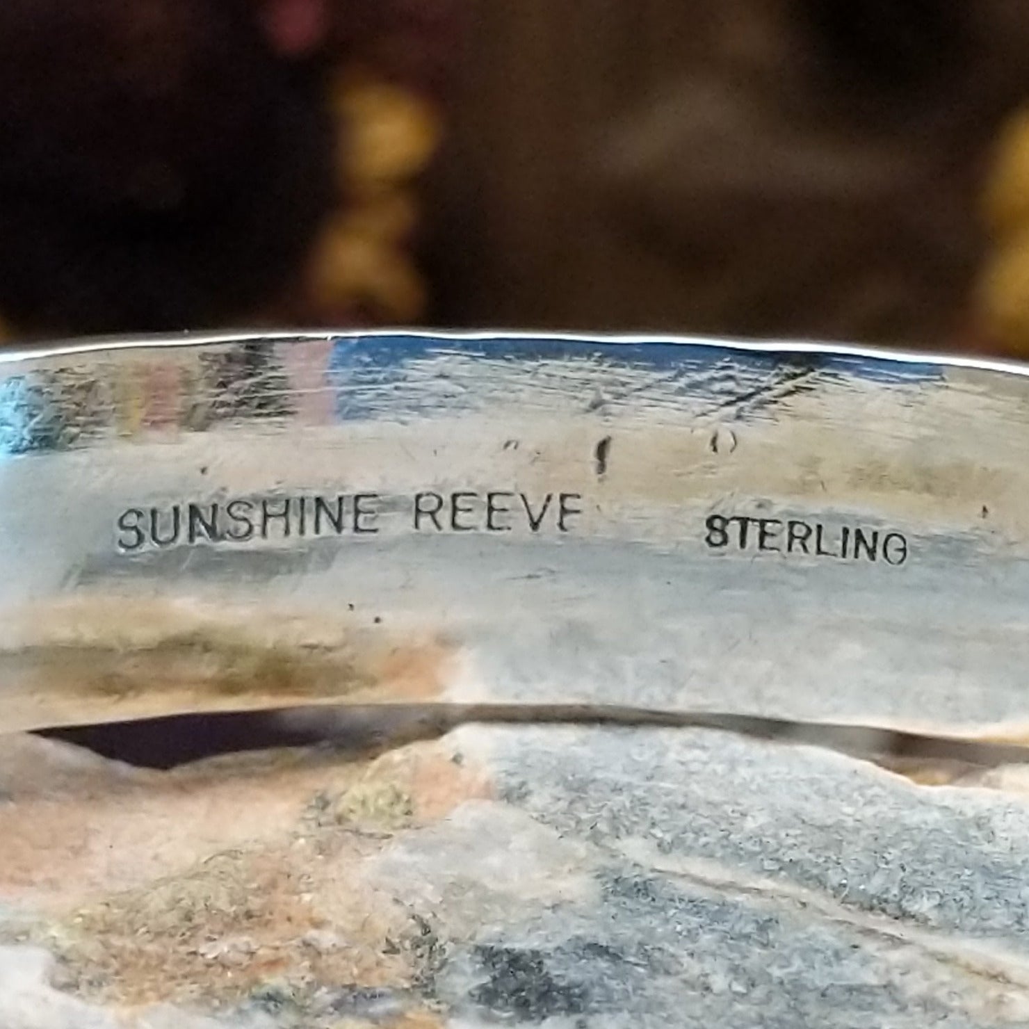 Handcrafted sterling silver cuff bracelet by Sunshine Reeves featuring diamond-stamped geometric detailing in a traditional Navajo Southwestern design.  Artisan and Sterling Silver stamp.