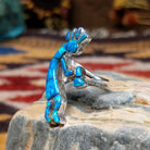 Handcrafted sterling silver ring by James Mason featuring a blue manmade opal and Kokopelli design in a traditional Southwestern Native American style.  Side view.
