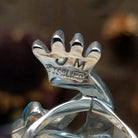 Handcrafted sterling silver ring by James Mason featuring a blue manmade opal and Kokopelli design in a traditional Southwestern Native American style.  Artisan and Sterling Silver stamp.
