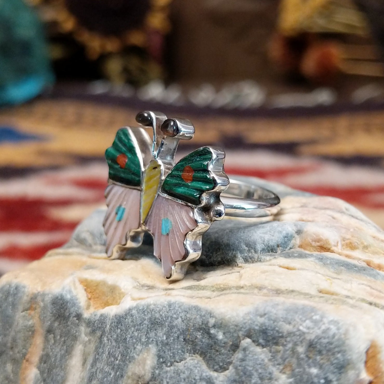 Handcrafted Zuni sterling silver butterfly ring featuring colorful multistone inlay work in a traditional Southwestern Native American design.  Side view.