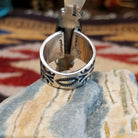 Handcrafted sterling silver ring by Bernyse Chavez featuring an elongated White Buffalo stone with natural black-and-white patterns in a Southwestern Native American design.  Underside view.