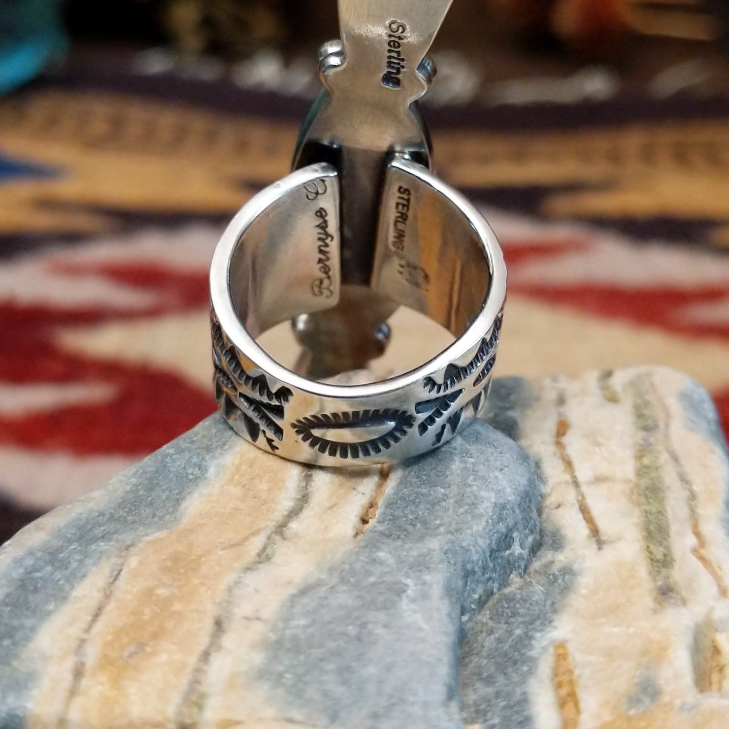 Handcrafted sterling silver ring by Bernyse Chavez featuring an elongated White Buffalo stone with natural black-and-white patterns in a Southwestern Native American design.  Underside view.