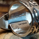 Handcrafted sterling silver ring by Bernyse Chavez featuring an elongated White Buffalo stone with natural black-and-white patterns in a Southwestern Native American design.  Artisan and Sterling Silver stamp.