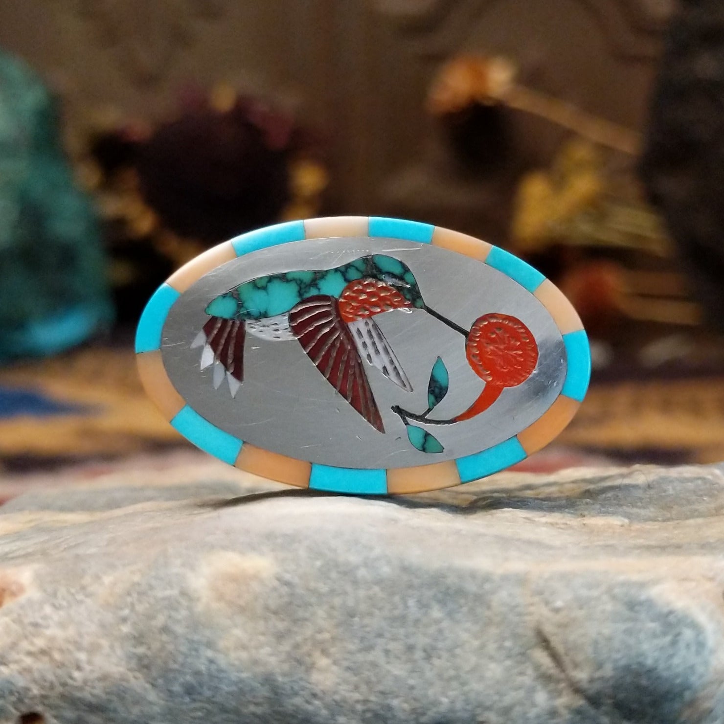Handcrafted sterling silver hummingbird ring by Albert and Dolly Banteah featuring colorful multistone inlay in a traditional Zuni Southwestern design.