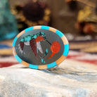 Handcrafted sterling silver hummingbird ring by Albert and Dolly Banteah featuring colorful multistone inlay in a traditional Zuni Southwestern design.  Side view.