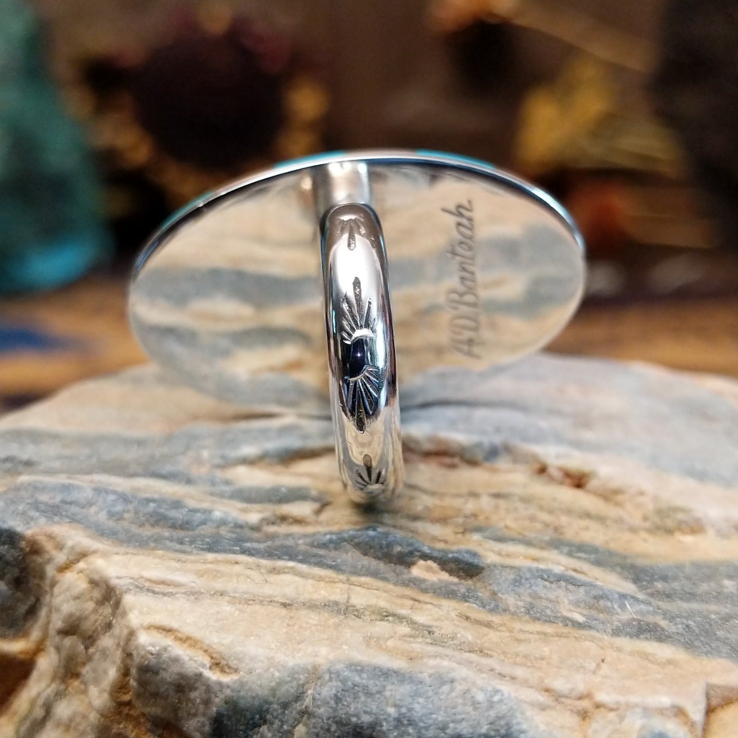 Handcrafted sterling silver hummingbird ring by Albert and Dolly Banteah featuring colorful multistone inlay in a traditional Zuni Southwestern design.  Underside view.