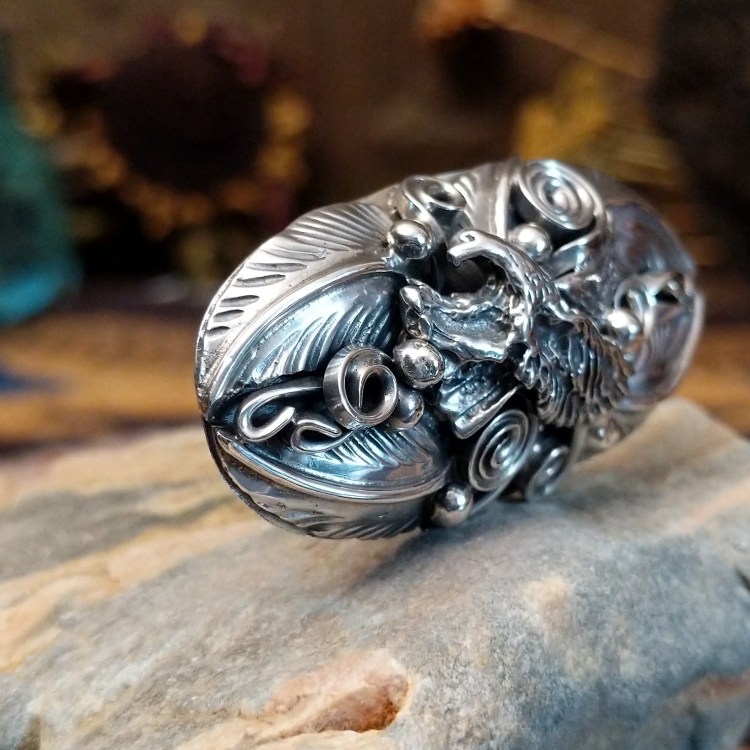 Handcrafted sterling silver ring by Navajo artist Allen Chee featuring a detailed eagle design in a traditional Southwestern Native American style.  Side view.