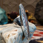 Handcrafted sterling silver navette ring by Ryan Sanchez featuring traditional stamped detailing in a Southwestern Native American design.  Side view.