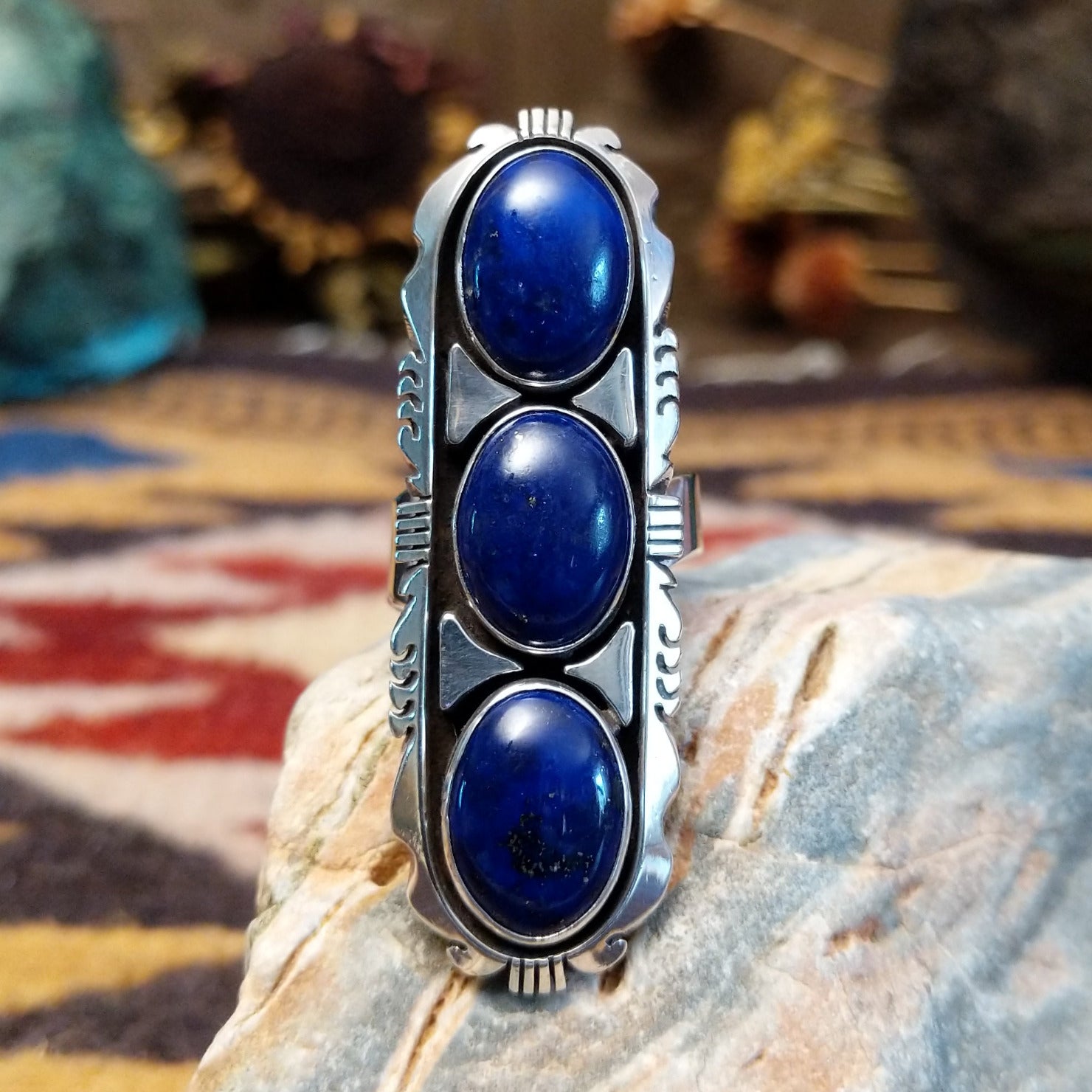 Handcrafted sterling silver ring by Toledo featuring three oval lapis stones in a vertical arrangement with geometric silver accents in a traditional Southwestern Native American design.