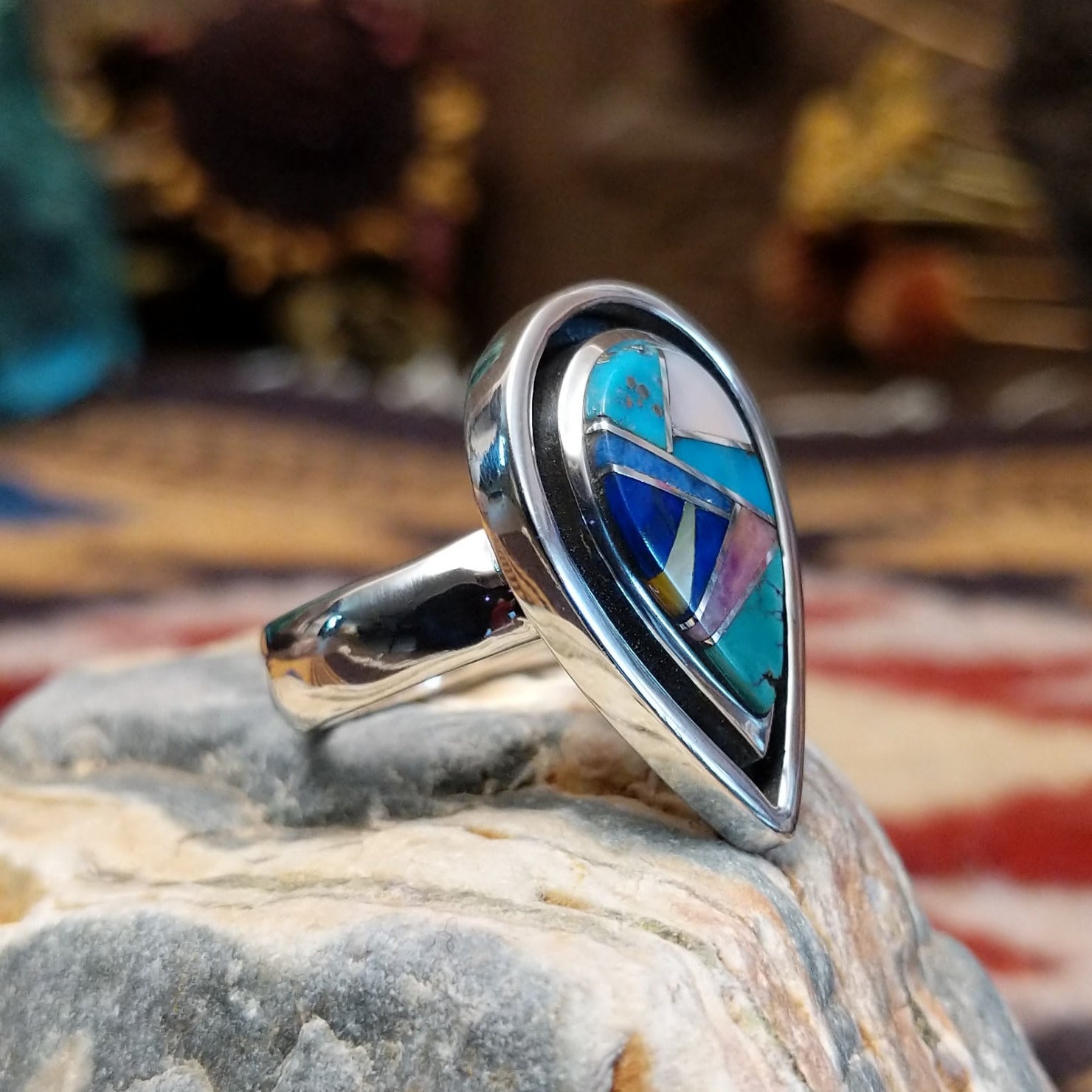 Handcrafted Navajo sterling silver teardrop ring by R.L. featuring colorful multistone inlay work in a traditional Southwestern Native American design.  Side view.