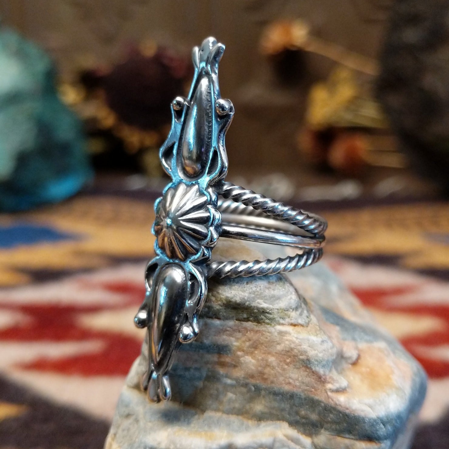 Handcrafted Navajo sterling silver ring featuring intricate silver detailing and traditional Southwestern craftsmanship in a bold regal design.  Side view.