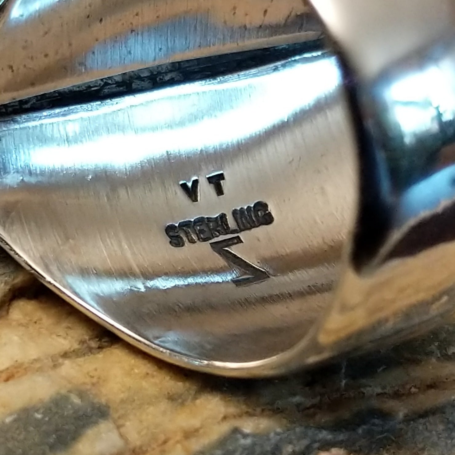 Handcrafted Navajo sterling silver ring by V.T. featuring a deep blue lapis stone in an abstract Southwestern design with intricate silver detailing.  Artisan nd Sterling Silver stamp.