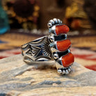 Handcrafted sterling silver ring by Bernyse Chavez featuring multiple stacked coral stones in a bold vertical arrangement with traditional Southwestern Native American detailing.  Side view.
