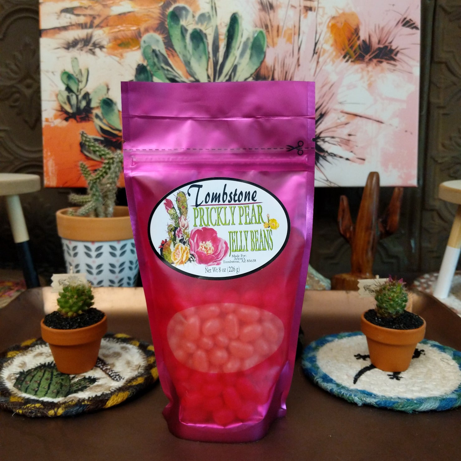 Colorful prickly pear jelly beans displayed in a pile, featuring vibrant pink and purple hues inspired by the sweet fruit of the prickly pear cactus.