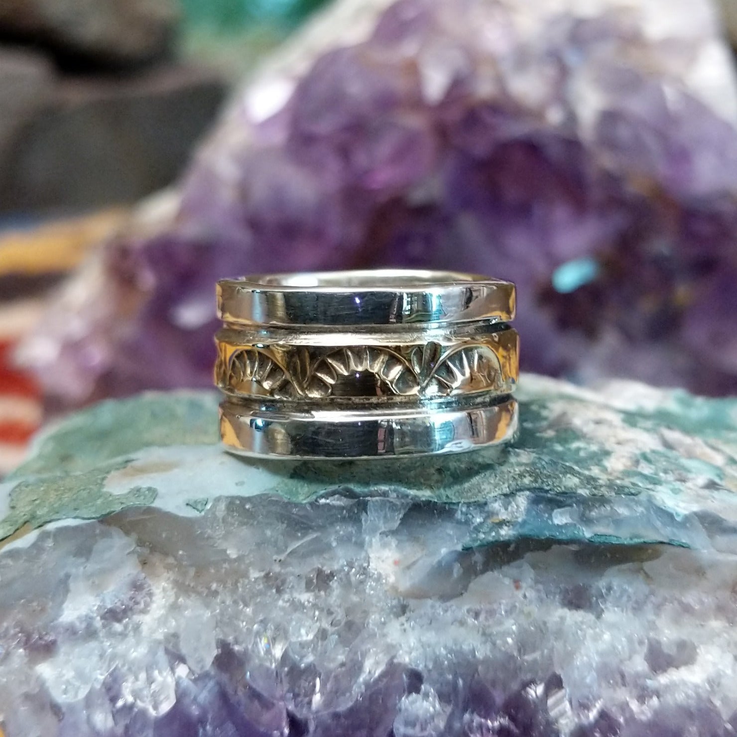 Handcrafted sterling silver and 14K gold band ring by Marc Antia featuring a stamped gold center with polished silver edges in a Southwestern Native American design.