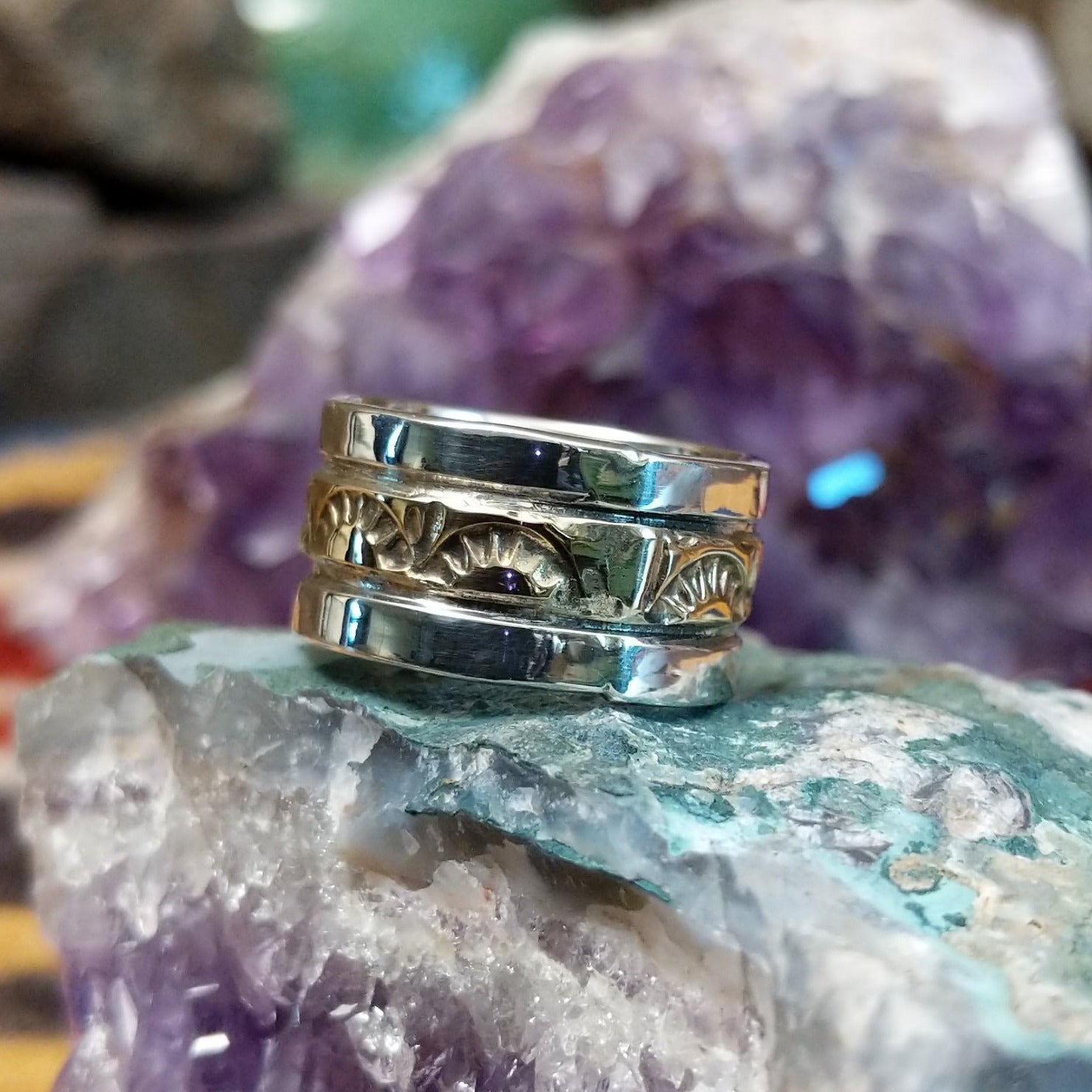 Handcrafted sterling silver and 14K gold band ring by Marc Antia featuring a stamped gold center with polished silver edges in a Southwestern Native American design.  