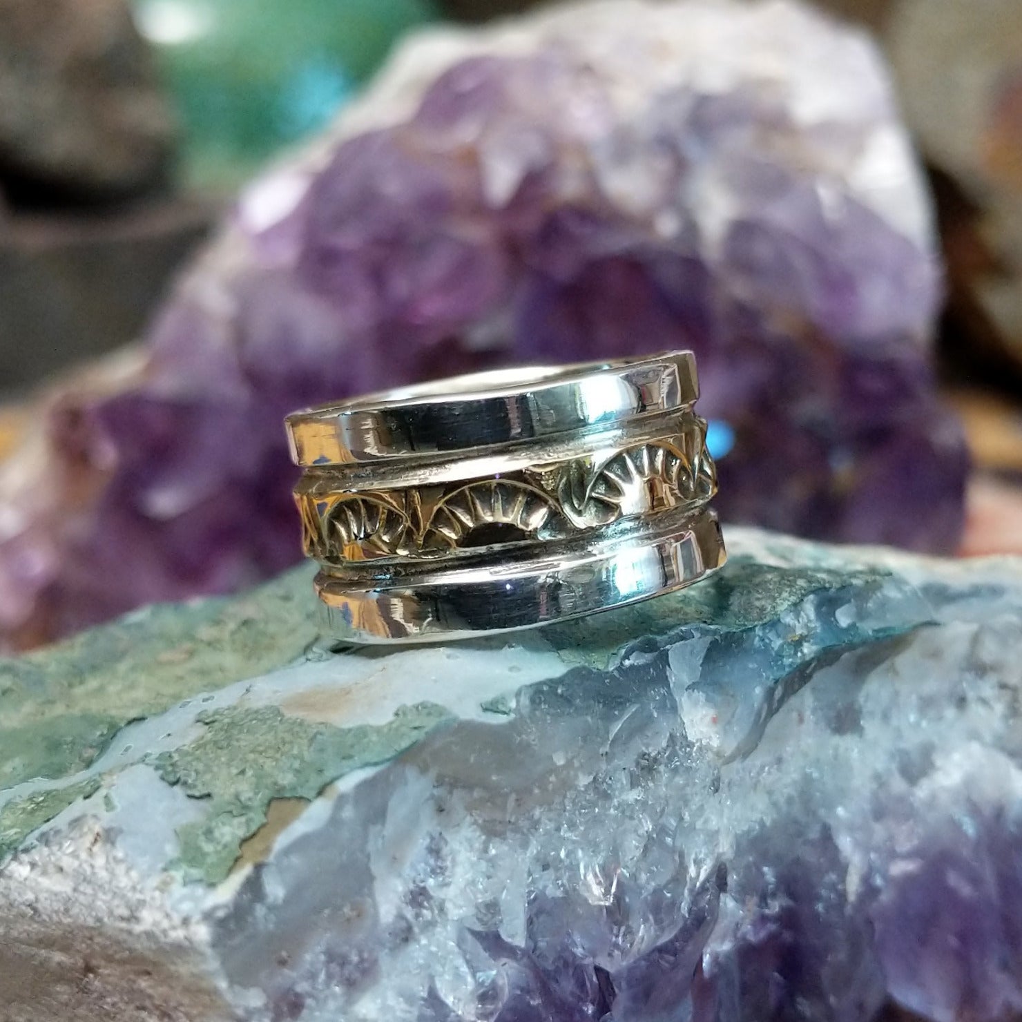 Handcrafted sterling silver and 14K gold band ring by Marc Antia featuring a stamped gold center with polished silver edges in a Southwestern Native American design.