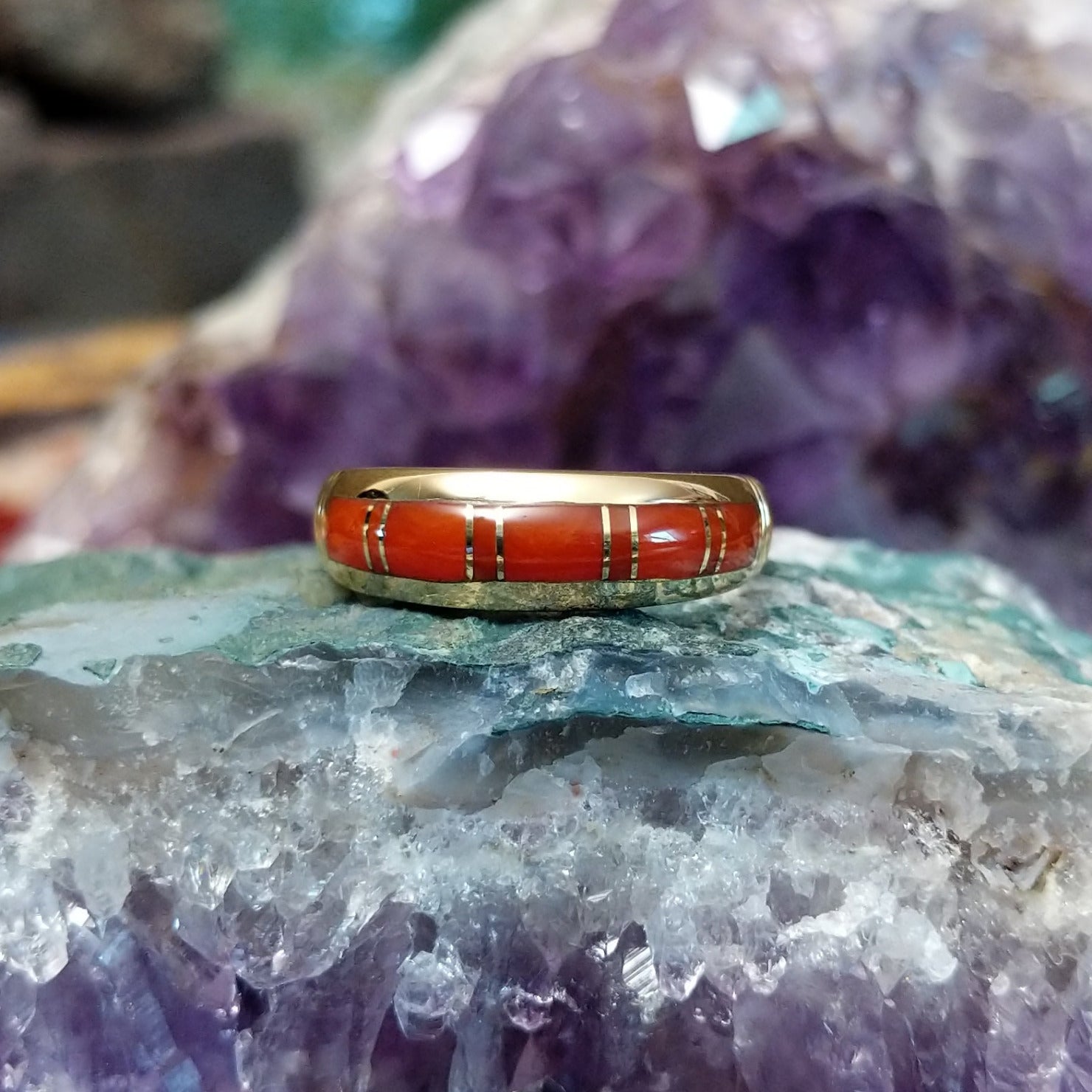 Handcrafted Navajo 14K gold ring featuring red coral inlay in a polished Southwestern Native American design.