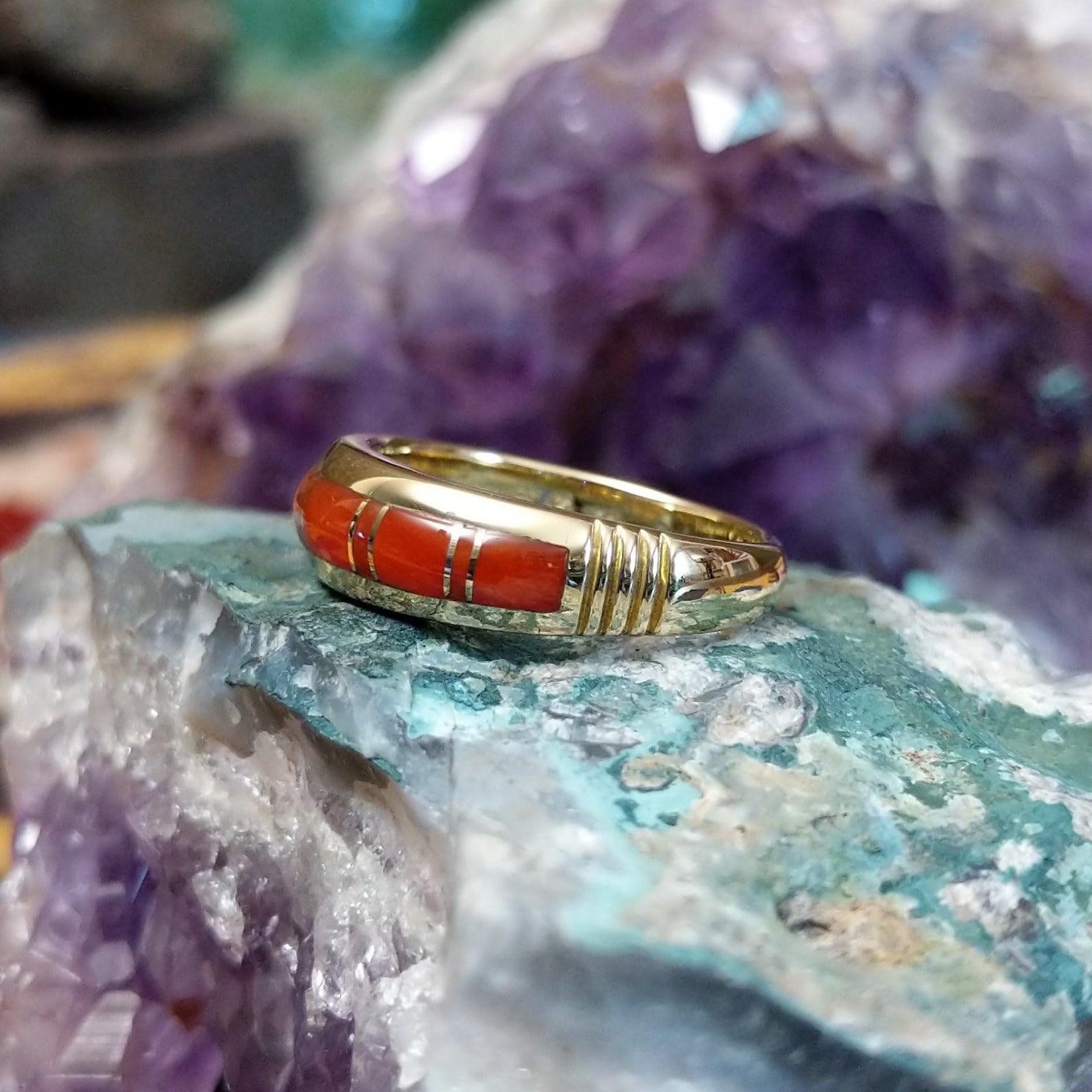 Handcrafted Navajo 14K gold ring featuring red coral inlay in a polished Southwestern Native American design.  Side view.