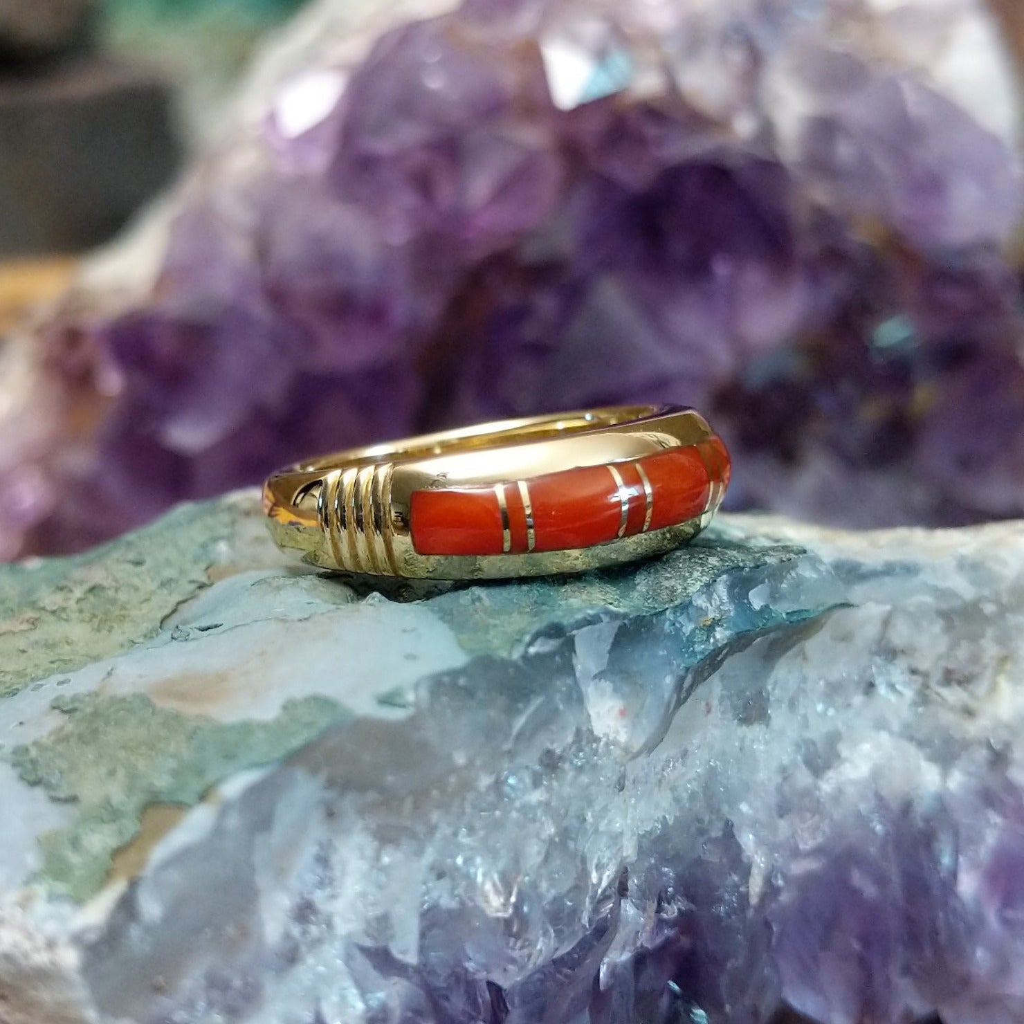 Handcrafted Navajo 14K gold ring featuring red coral inlay in a polished Southwestern Native American design.  Side view.