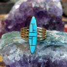 Handcrafted 14K gold navette ring by R.D. featuring vibrant turquoise inlay in a traditional Southwestern Native American design.