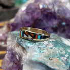 Zuni multistone inlay ring in 14K yellow gold by Charlotte Dishta, featuring precise geometric inlay work with multiple natural stones set into a polished gold band.  Side view.