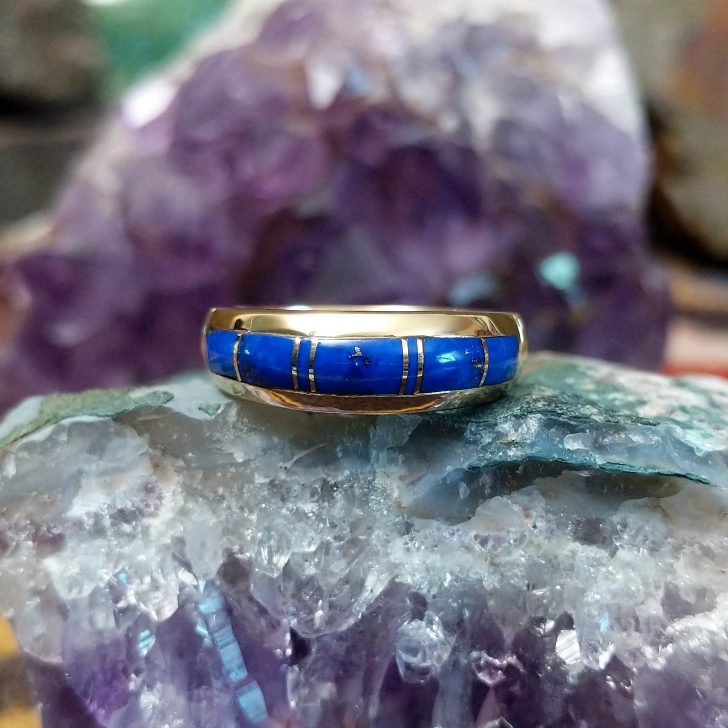 Navajo lapis inlay ring in 14K yellow gold, featuring deep blue lapis lazuli with natural flecks of pyrite set in a smooth polished gold band.
