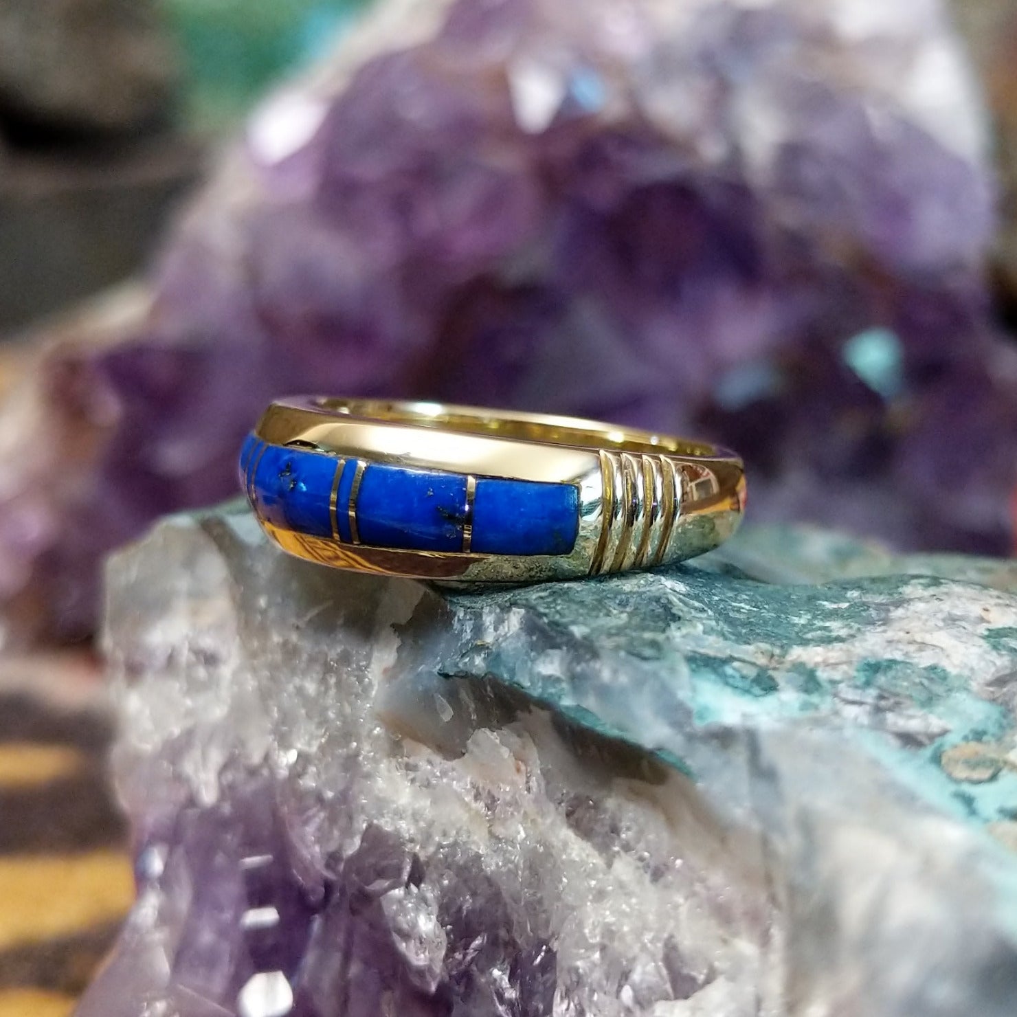 Navajo lapis inlay ring in 14K yellow gold, featuring deep blue lapis lazuli with natural flecks of pyrite set in a smooth polished gold band.  Side view.