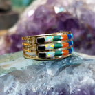 Three row multistone inlay ring in 14K yellow gold by Tom Billy, featuring colorful stone inlay arranged in three parallel rows within a polished gold band.  Side view.