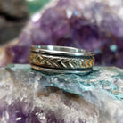 Silver and 14K gold stamped ring by Bruce Morgan, featuring handcrafted geometric stamp work, gold accents, and a polished sterling silver band.