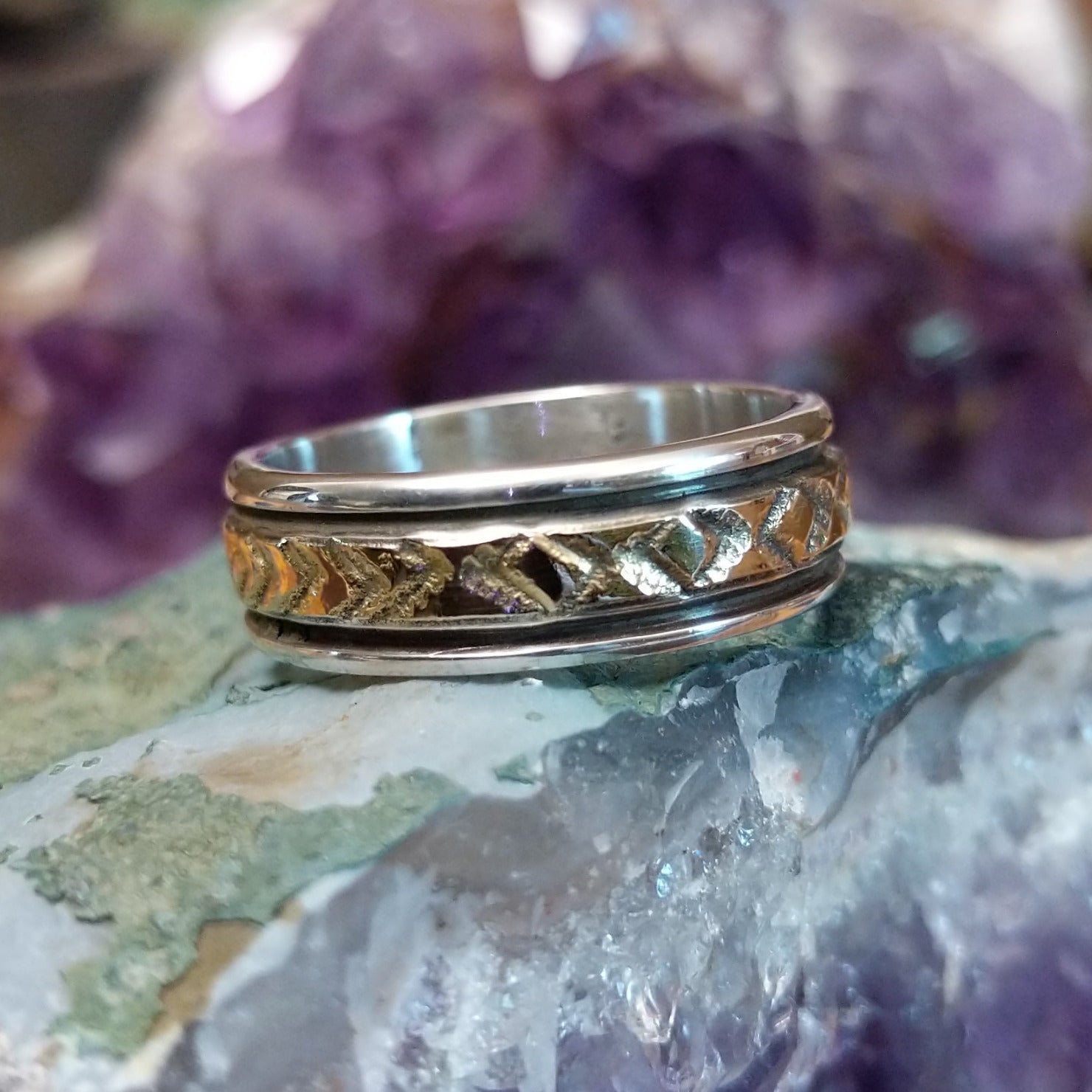 Silver and 14K gold stamped ring by Bruce Morgan, featuring handcrafted geometric stamp work, gold accents, and a polished sterling silver band.