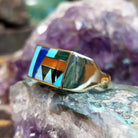 Multistone inlay ring in 14K yellow gold by Steve Francisco, featuring colorful stone inlay patterns set within a polished gold band.  Side view.