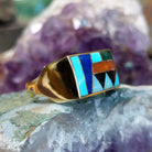 Multistone inlay ring in 14K yellow gold by Steve Francisco, featuring colorful stone inlay patterns set within a polished gold band.  Side view.