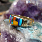 Navajo multistone mosaic inlay ring in 14K yellow gold, featuring a colorful arrangement of individually fitted stones set within a polished gold band.  Side view.