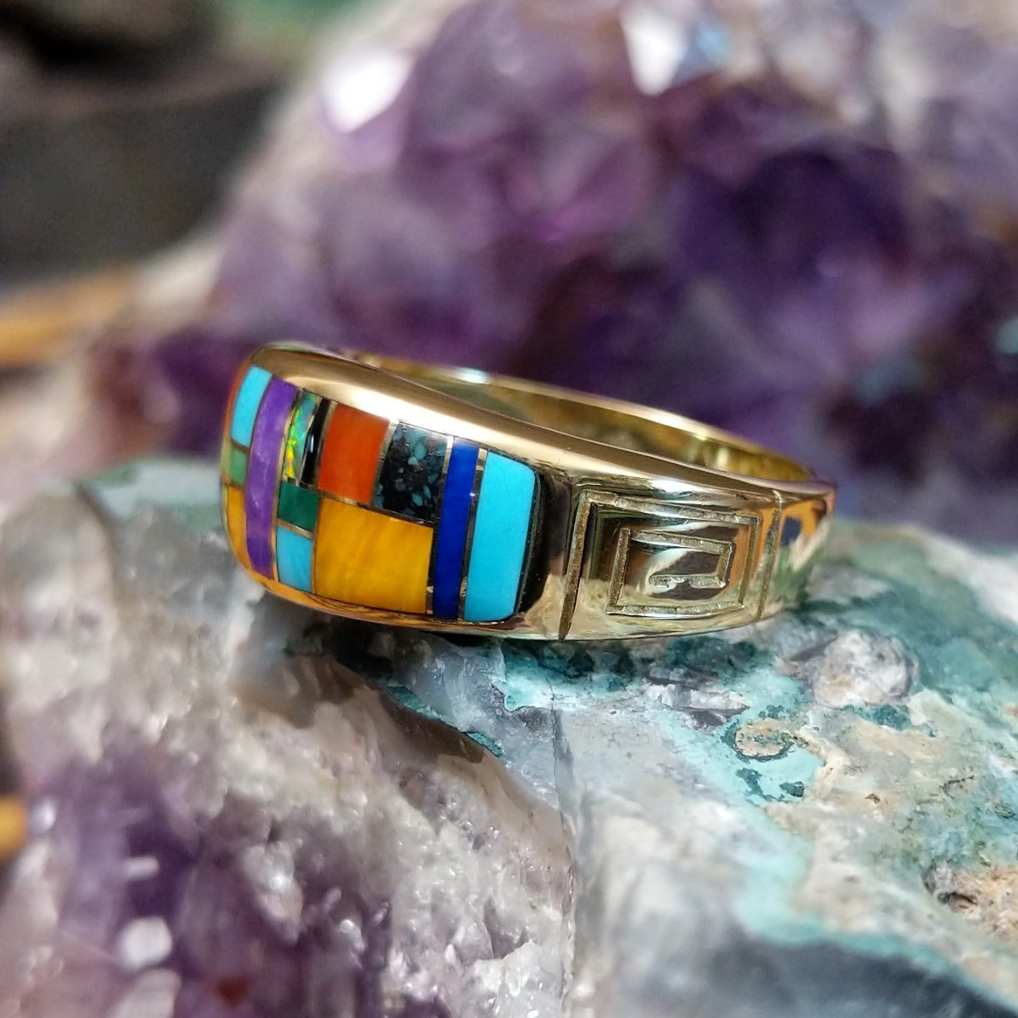 Navajo multistone mosaic inlay ring in 14K yellow gold, featuring a colorful arrangement of individually fitted stones set within a polished gold band.  Side view.
