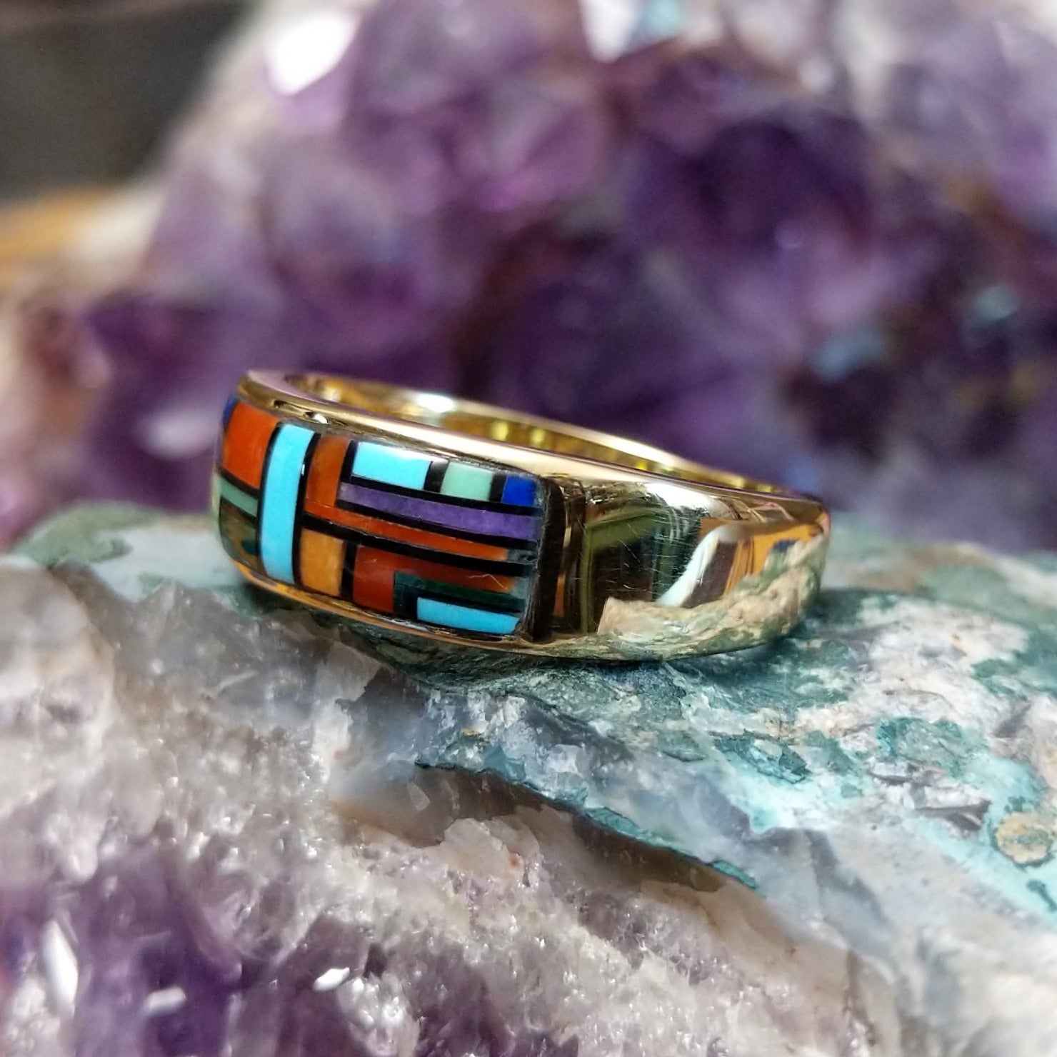 Multistone tiled inlay ring in 14K yellow gold by Steve Francisco, featuring a structured mosaic of individually cut stones set within a polished gold band.  Side view.