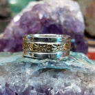 Silver and 14K gold stamped ring by Marc Antia, featuring hand-stamped geometric patterns, gold accents, and a polished sterling silver band.