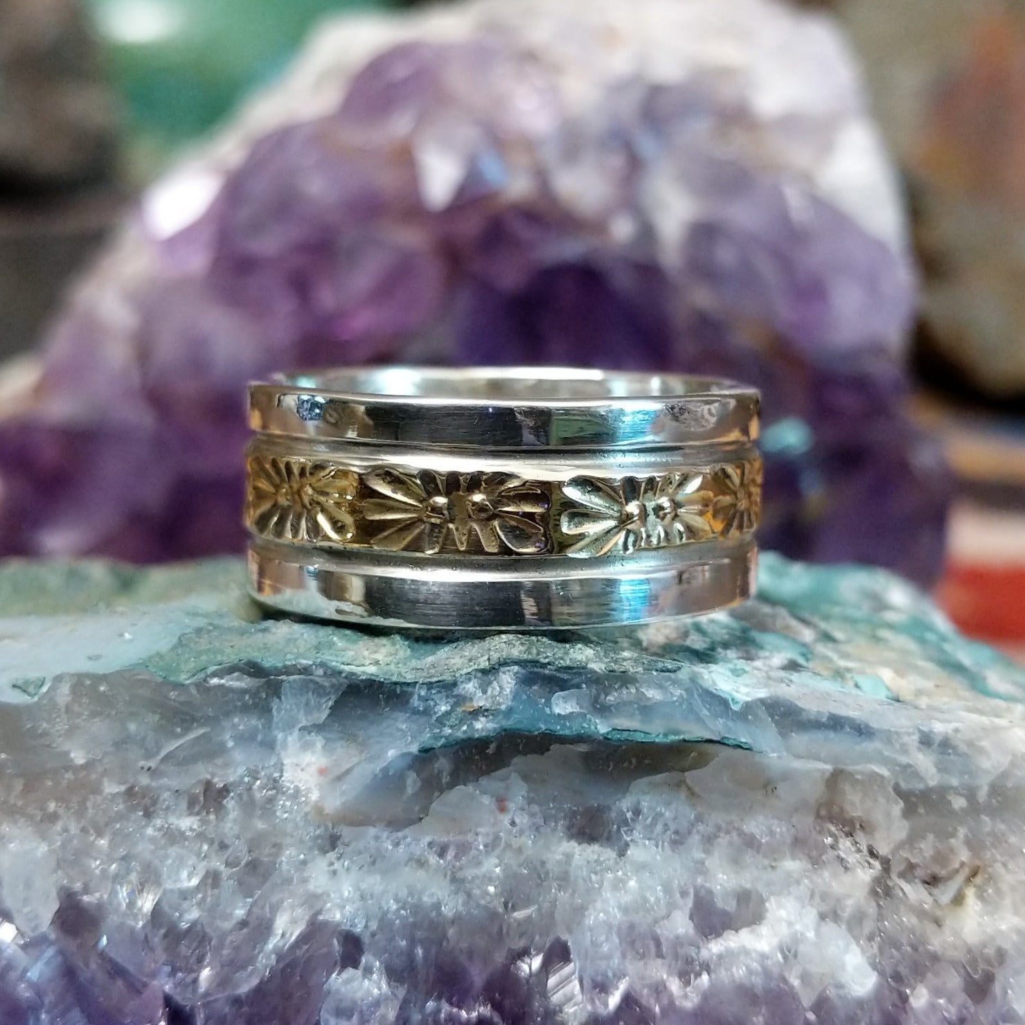 Silver and 14K gold stamped ring by Marc Antia, featuring hand-stamped geometric patterns, gold accents, and a polished sterling silver band.