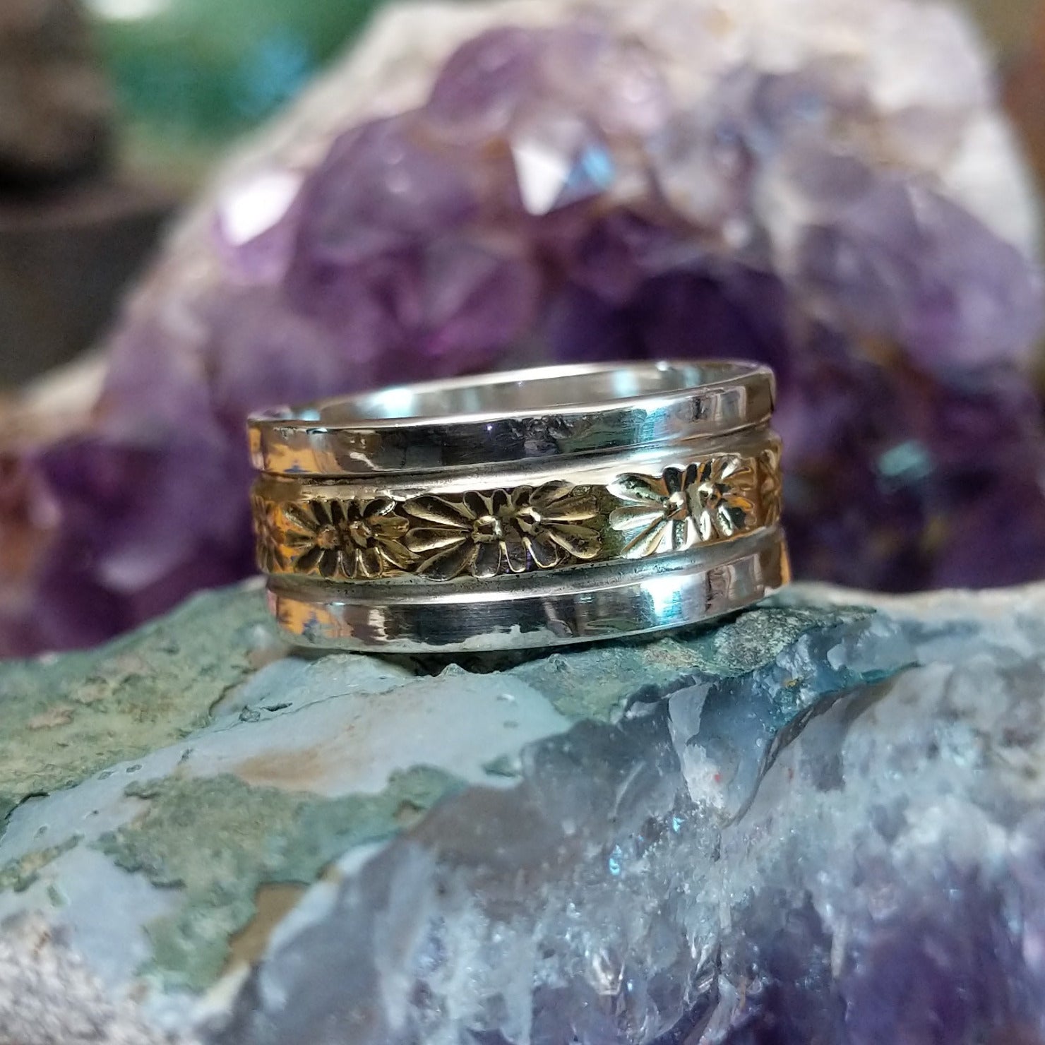 Silver and 14K gold stamped ring by Marc Antia, featuring hand-stamped geometric patterns, gold accents, and a polished sterling silver band.