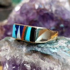 Multistone inlay ring in 14K yellow gold by Steve Francisco, featuring a vibrant mosaic of carefully fitted natural stones set within a polished gold band.  Side view.