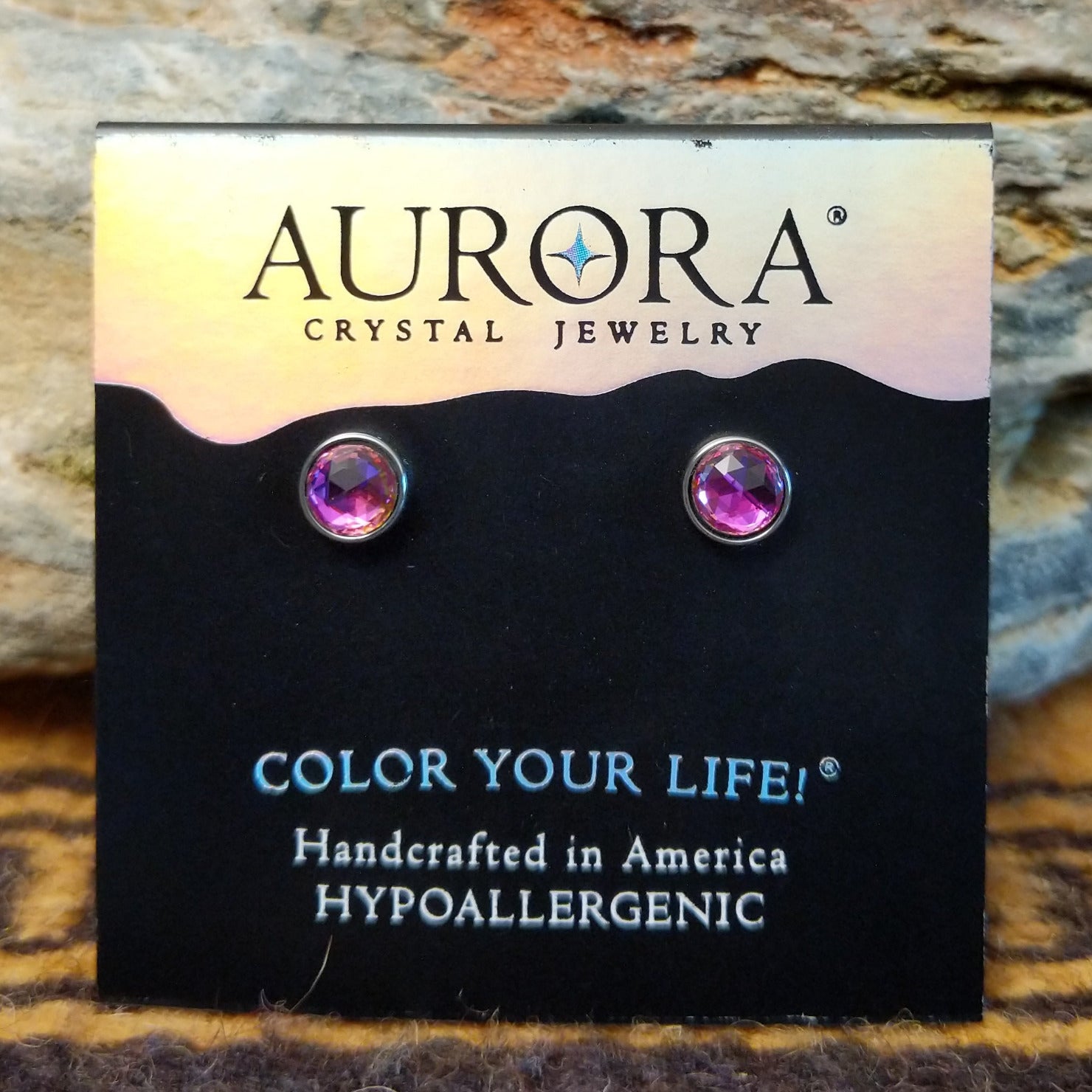 Aurora halo crystal stud earrings by LeightWorks, featuring faceted crystals surrounded by a sparkling halo setting with brilliant light-reflecting detail.