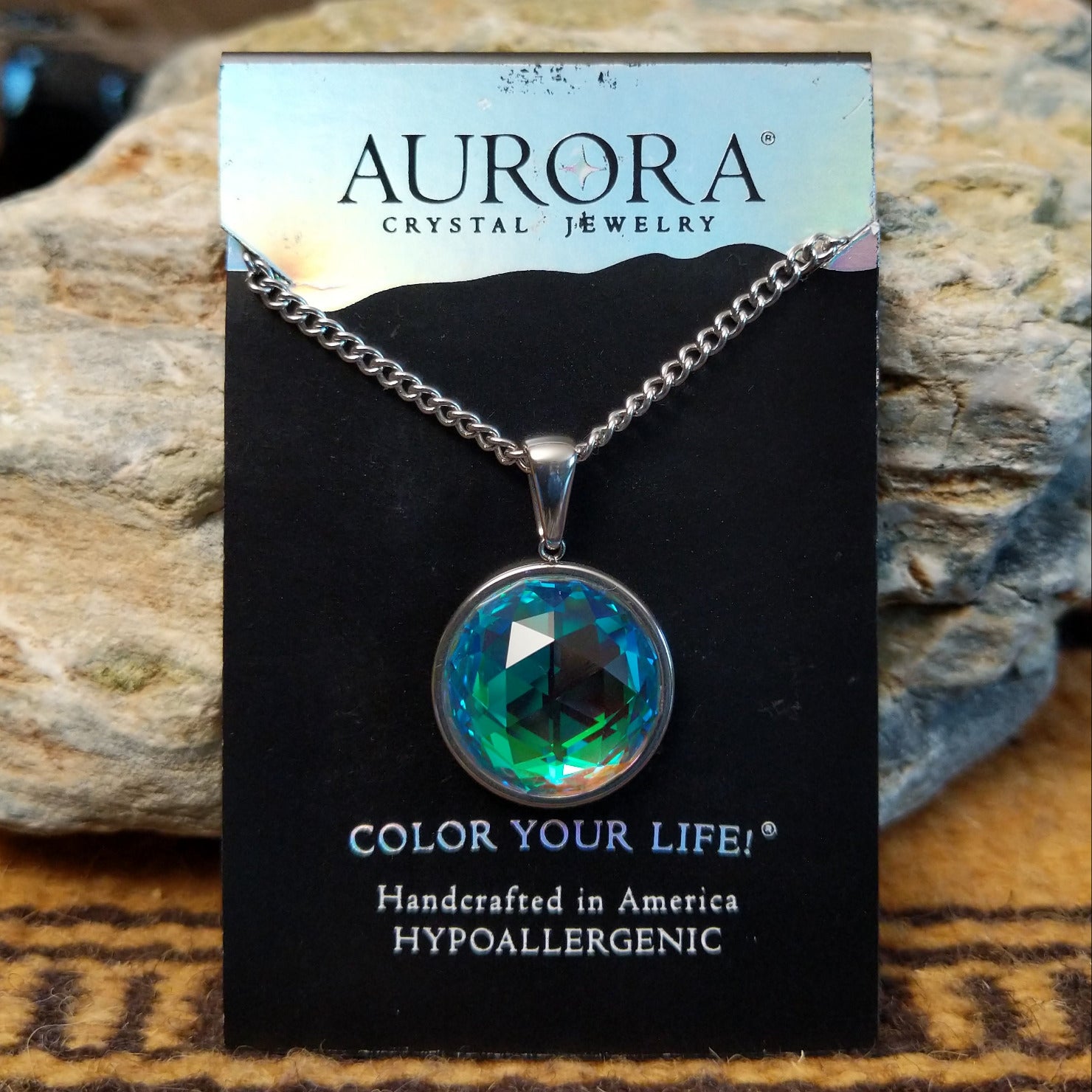 Aurora Eclipse crystal necklace by LeightWorks, featuring a sparkling faceted crystal pendant with brilliant light-reflecting detail on an elegant necklace chain.