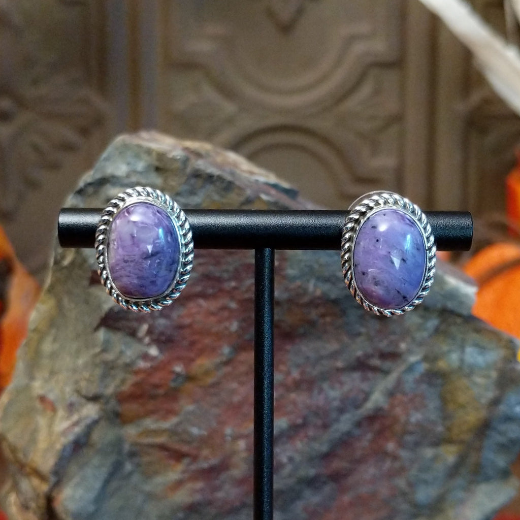 Charoite set in sterling silver bezels with twisted rope accents and stud backing of the earrings.