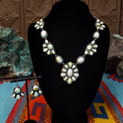 Palomino Variscite Sterling Silver necklace and matching earrings by Geraldine James, featuring white, cream, pale green, and yellow-green stones arranged in floral-style clusters.