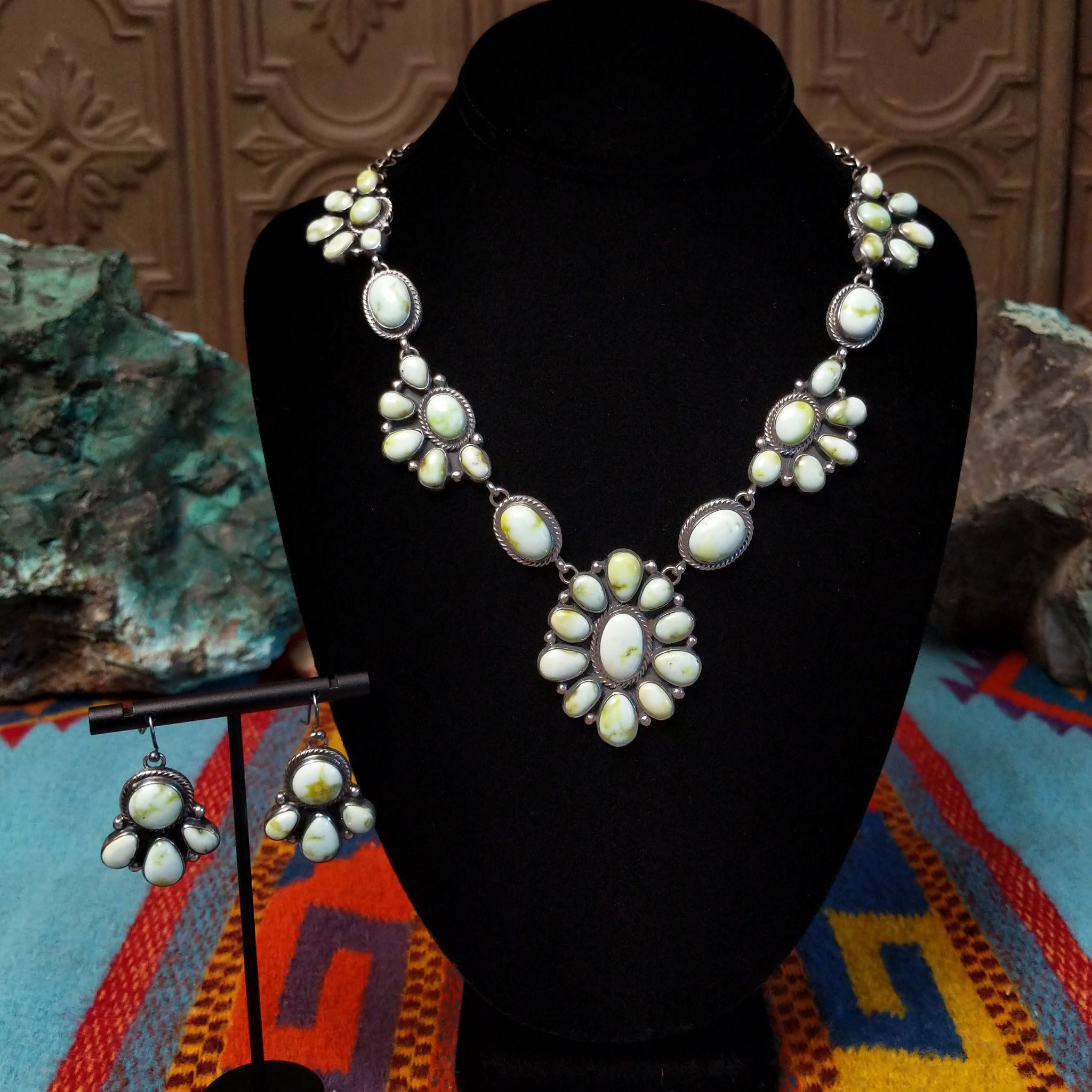 Palomino Variscite Sterling Silver necklace and matching earrings by Geraldine James, featuring white, cream, pale green, and yellow-green stones arranged in floral-style clusters.