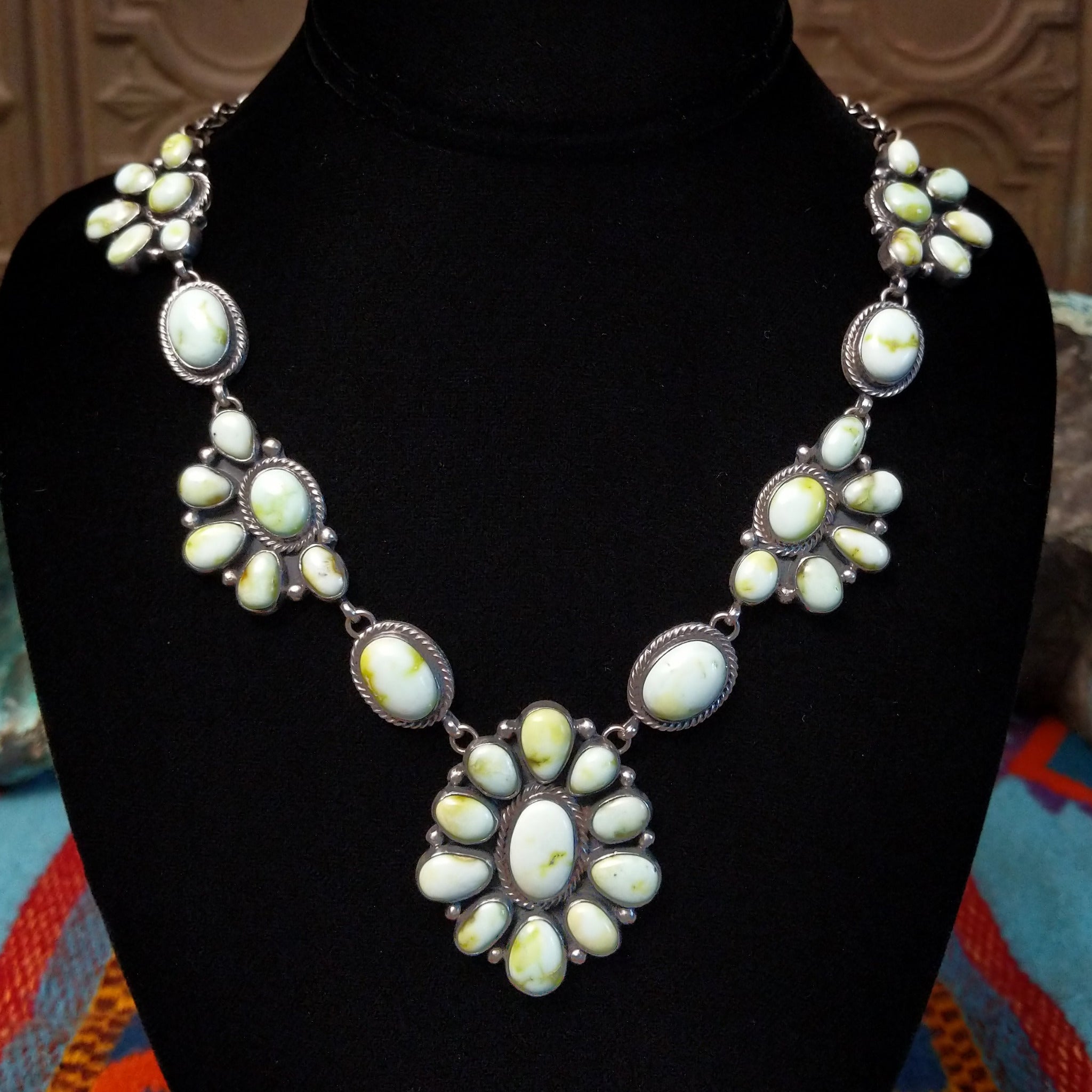 Palomino Variscite Sterling Silver necklace  by Geraldine James, featuring white, cream, pale green, and yellow-green stones arranged in floral-style clusters.