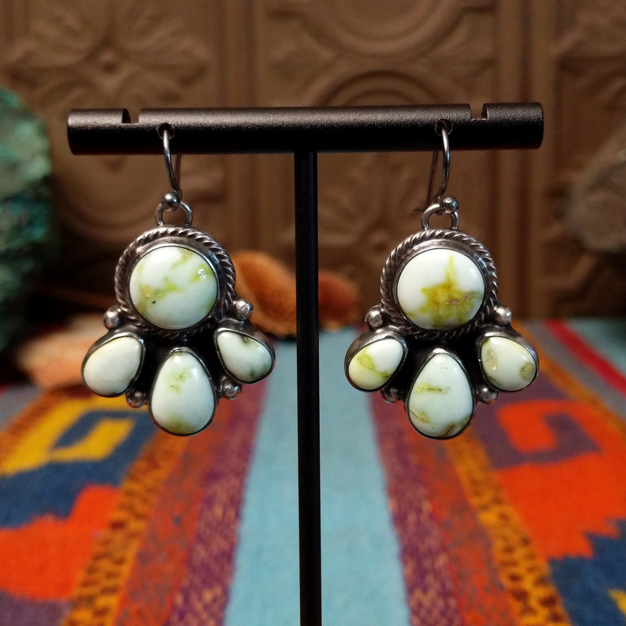 Palomino Variscite Sterling Silver earrings by Geraldine James, featuring white, cream, pale green, and yellow-green stones arranged in floral-style clusters.