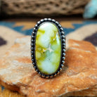 Handcrafted sterling silver Palomino Variscite oval ring by Raymond Coriz, featuring a natural green and white variscite gemstone with a beaded bezel.