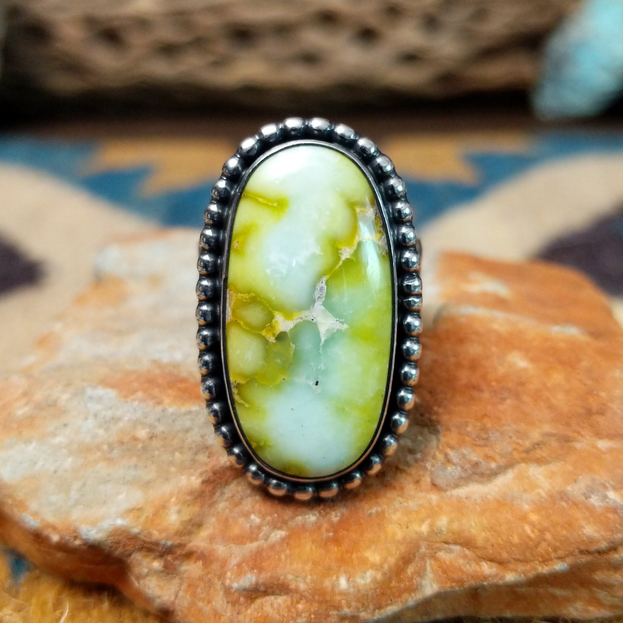 Handcrafted sterling silver Palomino Variscite oval ring by Raymond Coriz, featuring a natural green and white variscite gemstone with a beaded bezel.