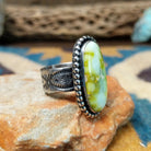 Handcrafted sterling silver Palomino Variscite oval ring by Raymond Coriz, featuring a natural green and white variscite gemstone with a beaded bezel; side view.